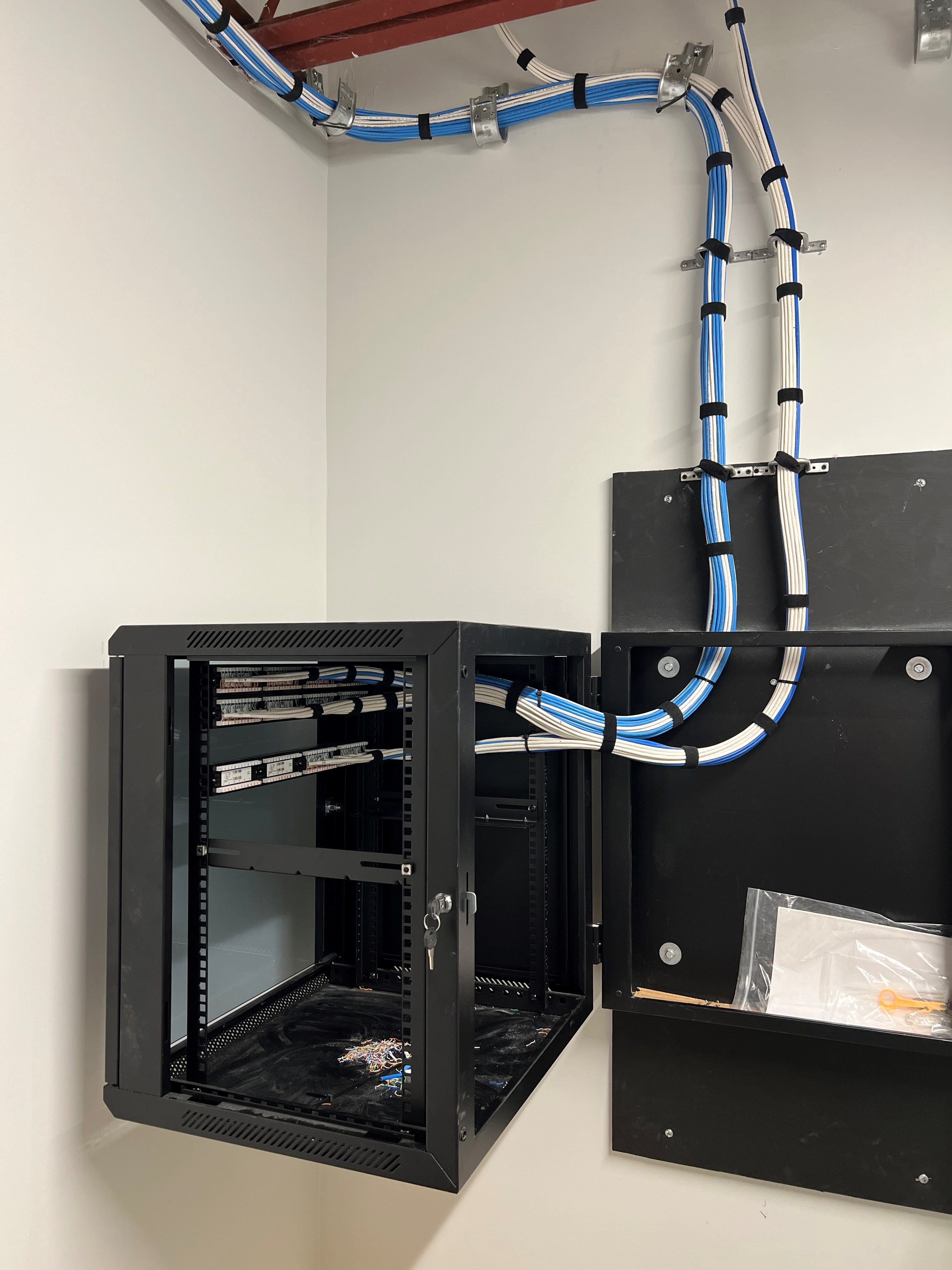 Wall-mounted network cabinet with structured cabling and patch panels