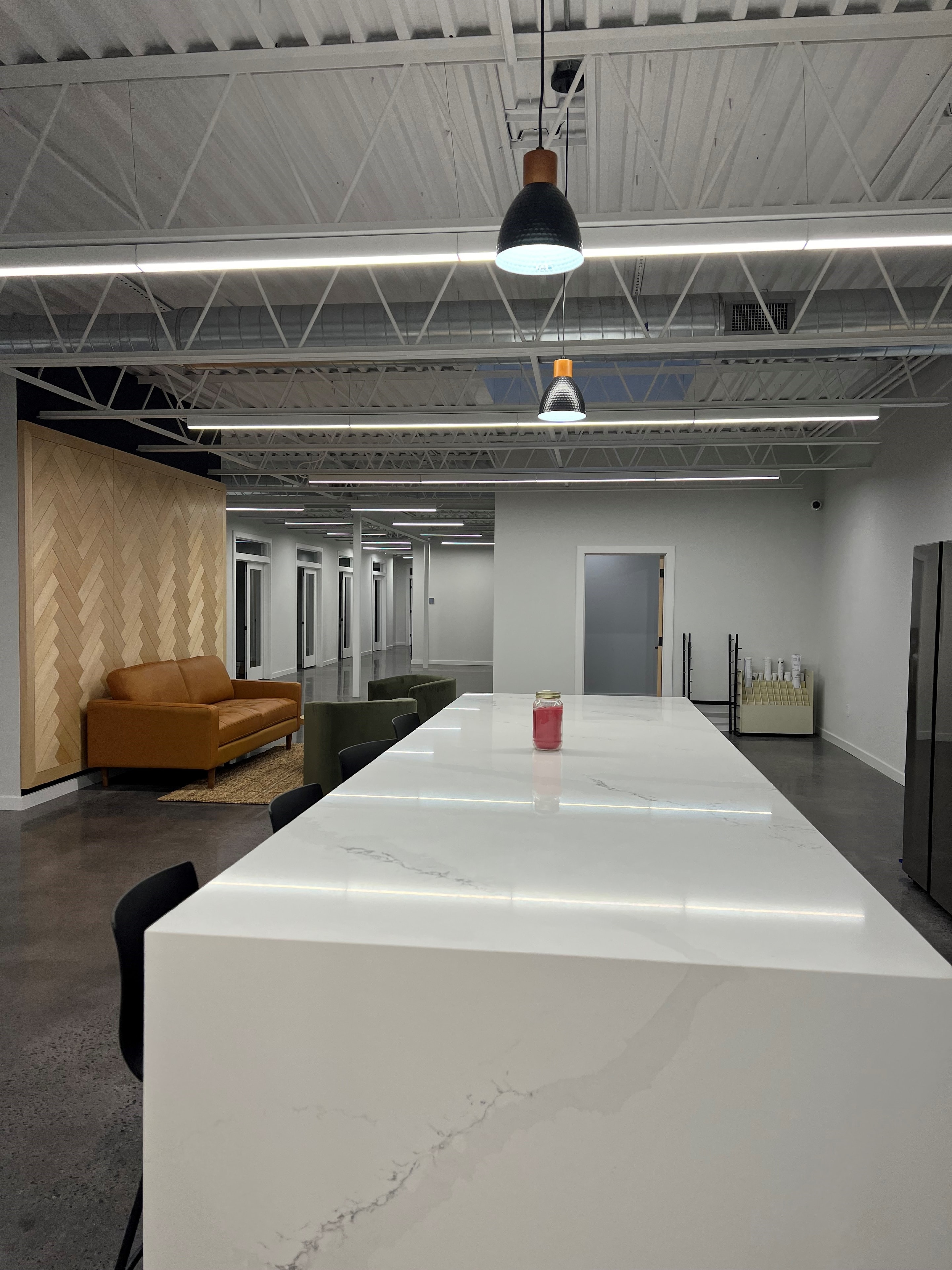 Pendant lighting and marble island installation in a commercial office break room