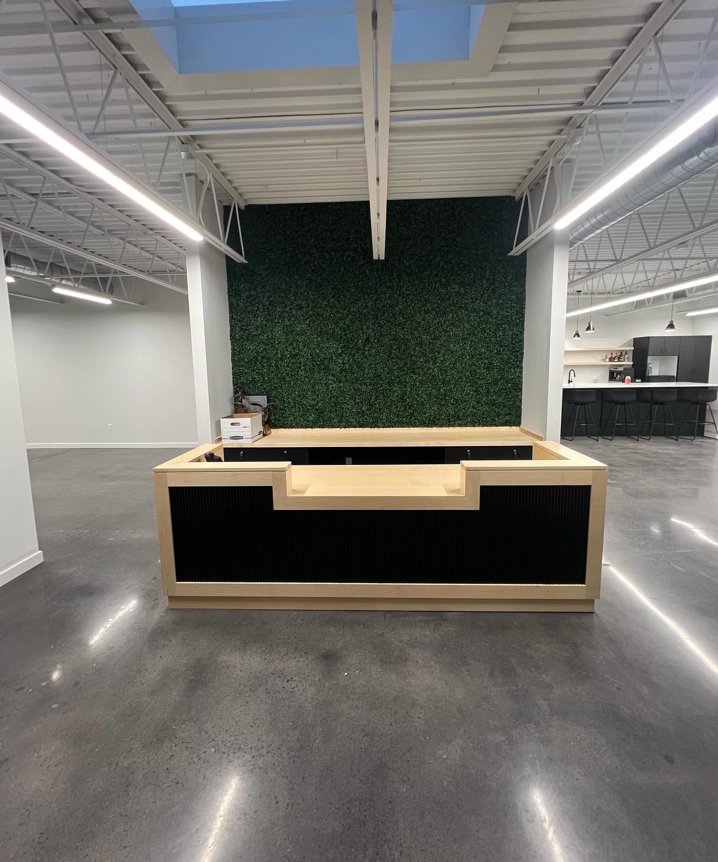 Reception desk wiring and lighting with living wall backdrop