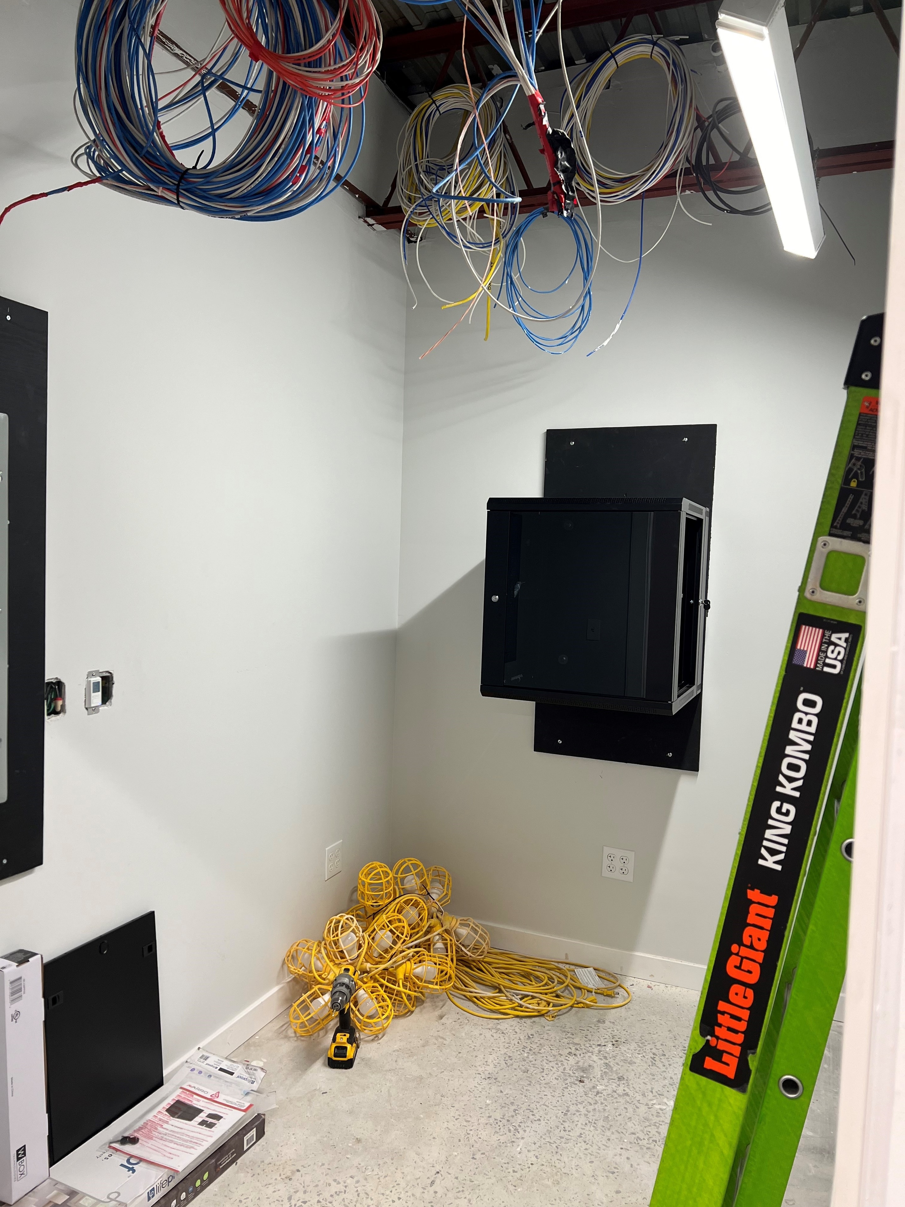 Structured cabling rough-in with wall-mount enclosure installation during construction