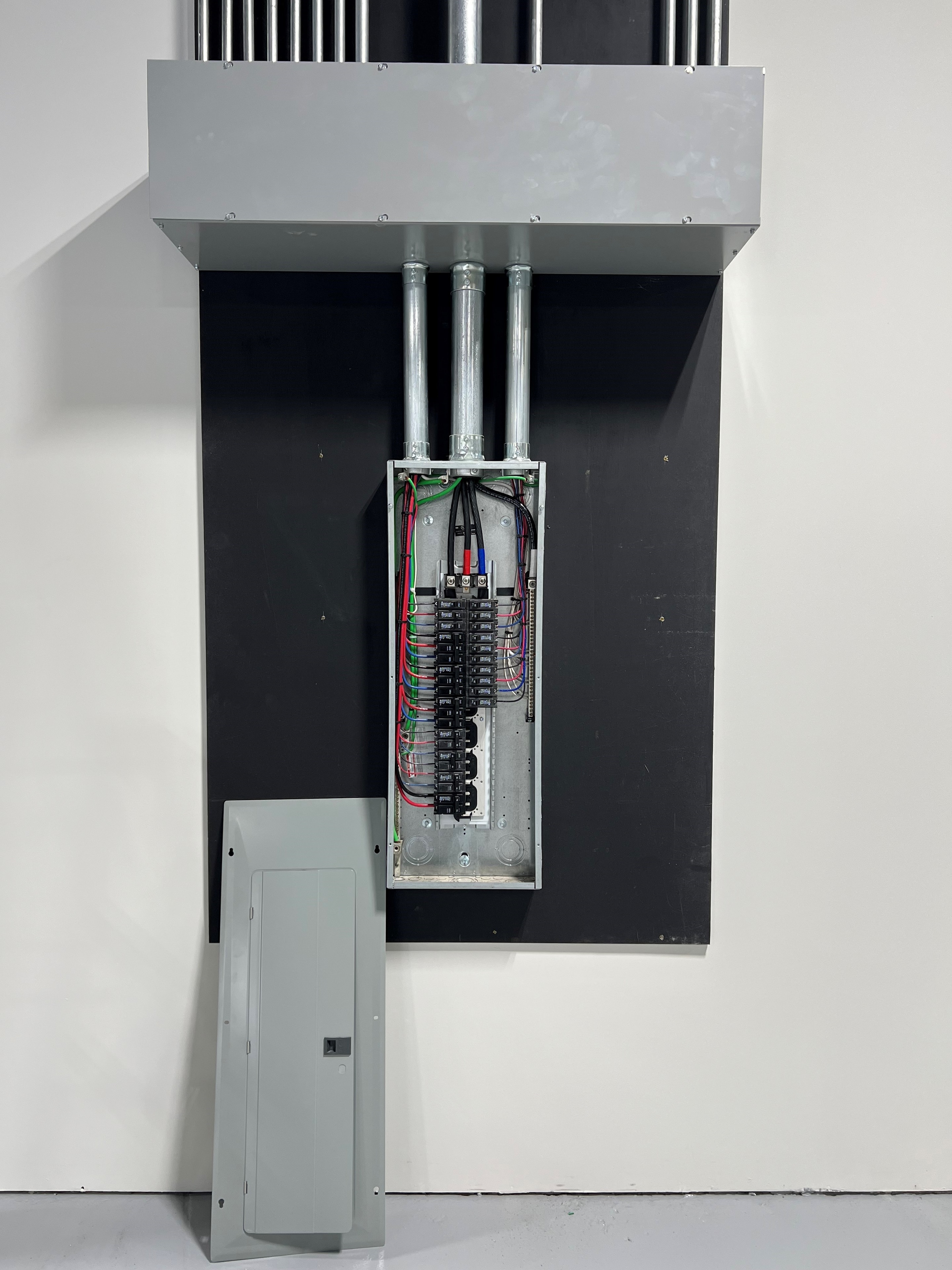 Commercial electrical panel installation with conduit feed and full circuit wiring