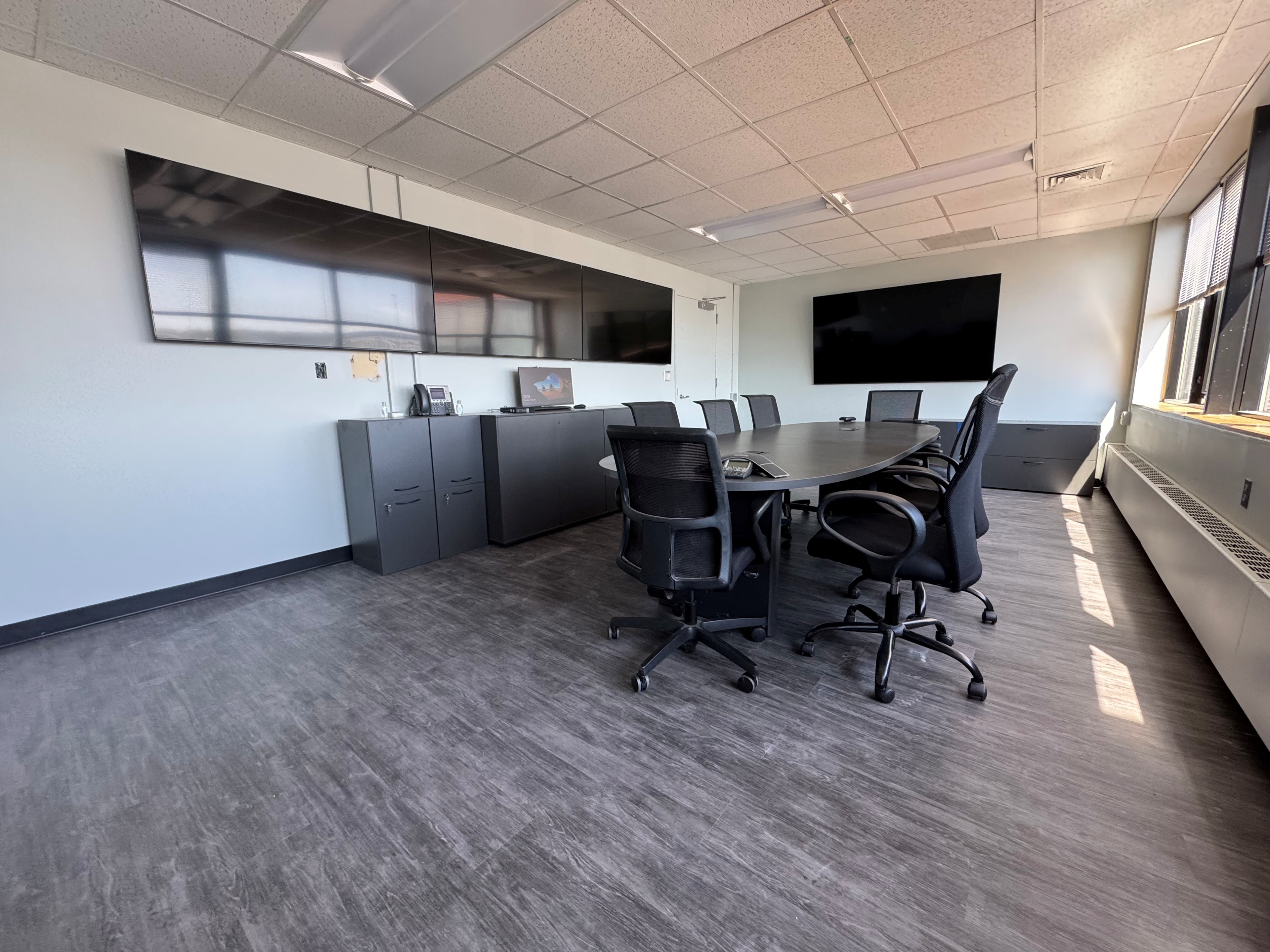 Full conference room with video walls