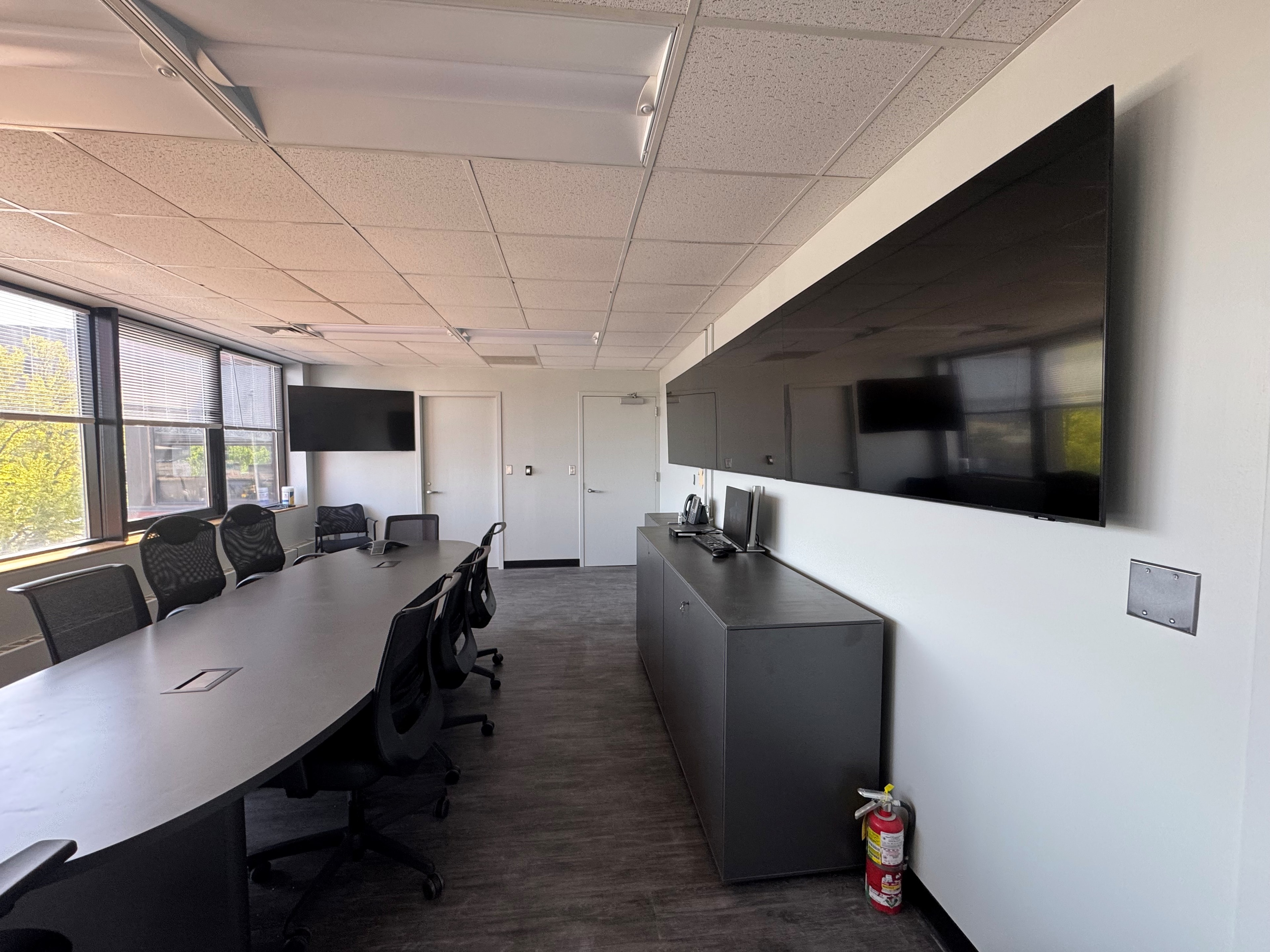 Full-length view of the conference room showing AV displays on both ends