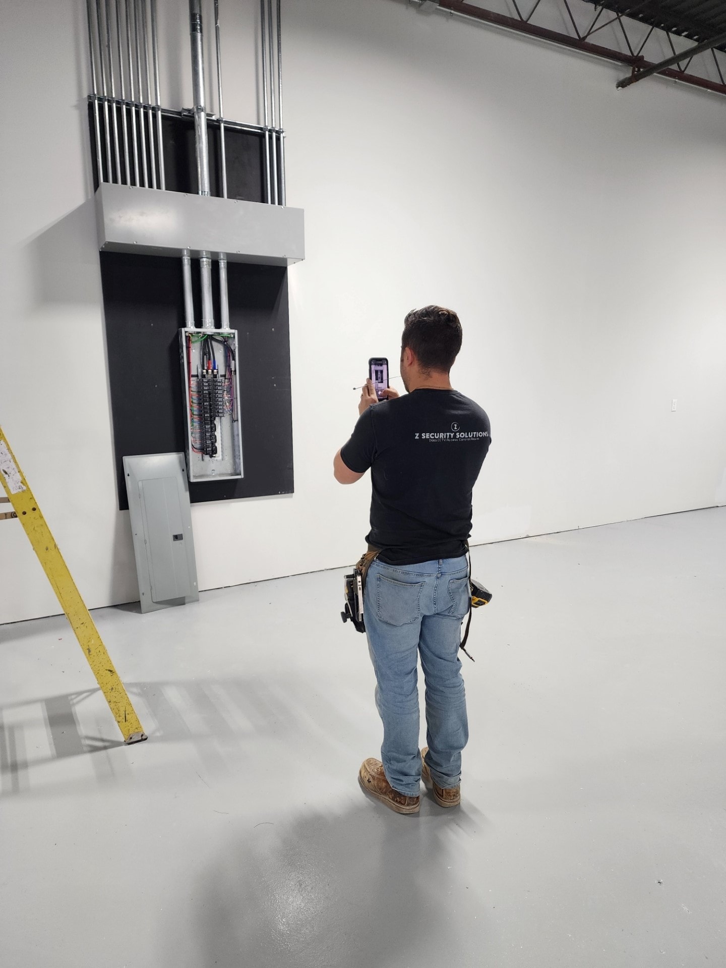 ZSS owner on site inspecting an electrical panel installation